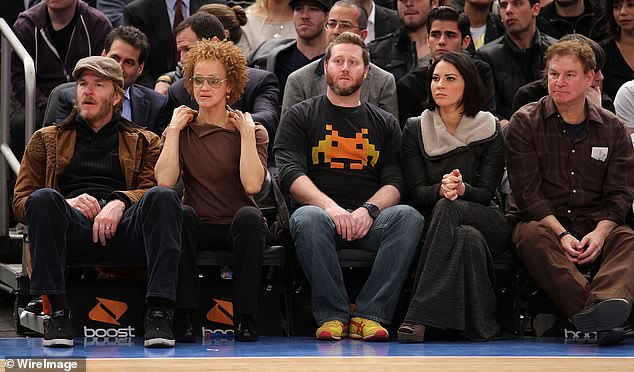 Work perks: (left) Modine and his wife Caridad Rivera sit courtside at a 2011 Knicks game