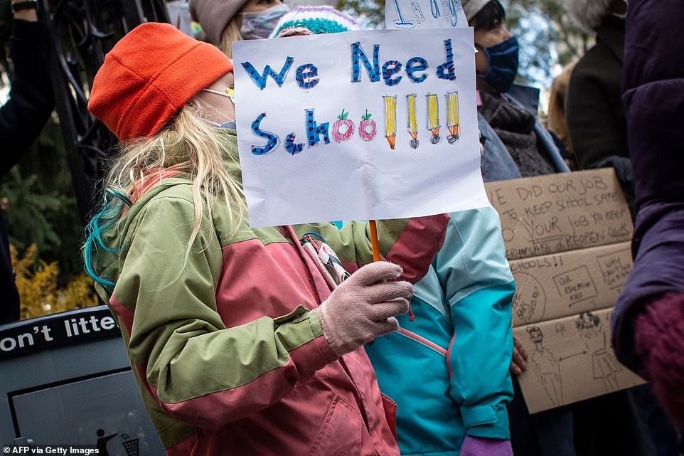 Children take part in a protest demanding that public schools remain open, outside New York's City Hall on November 19