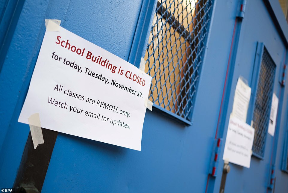 A sign on the door of a closed public school in Brooklyn. New York City Mayor Bill de Blasio announced that the city's entire public school system, the largest in the country, will indefinitely suspend all in-school classes