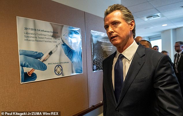 Newsom has been busy trying to manage a public health crisis in his state as COVID-19 cases have surged. He is seen above in in Sacramento on Thursday