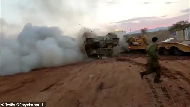 I'm outta here: Israeli soldier quickly moves away as smoke billows out of the tank