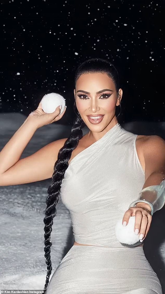 Winter wonderland: Sister Kim Kardashian had a snow theme for her new makeup collection from KKW. The siren, 40, wore a slinky outfit as she was seen throwing snowballs while smiling
