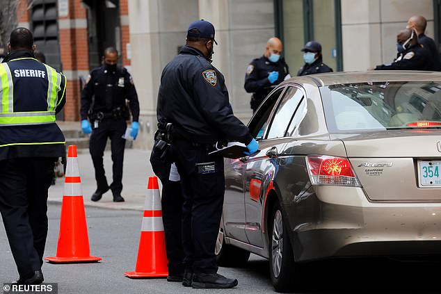 New York City Police Department Sheriffs stop vehicles at a checkpoint to perform COVID-19 compliance checks on drivers entering Manhattan from the Holland Tunnel