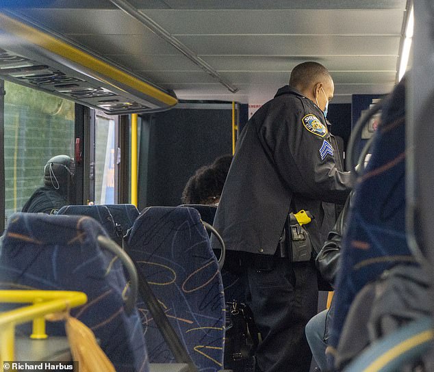 An NYPD officer inspects a Megabus at a Covid checkpoint in Manhattan on Wednesday