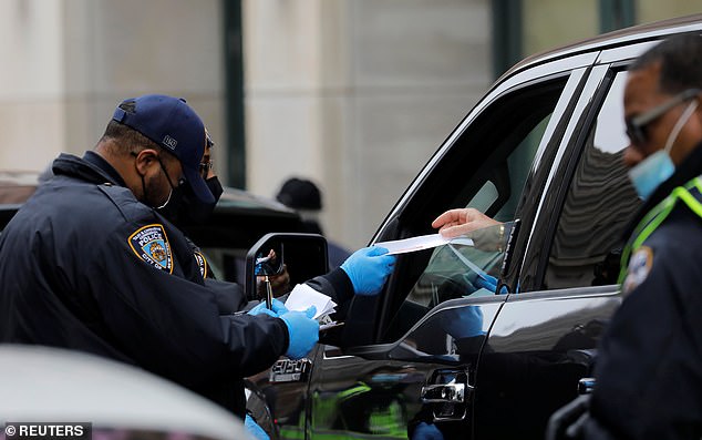 In New York City, checkpoints at bridges, tunnels and other keys crossings will have cops out 'in force' to inform travelers of the state's quarantine requirements. Pictured on Wednesday