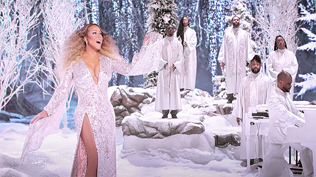 Mariah Carey, 50, Is The Christmas Queen Rocking A Stunning White Gown & More In Holiday Special