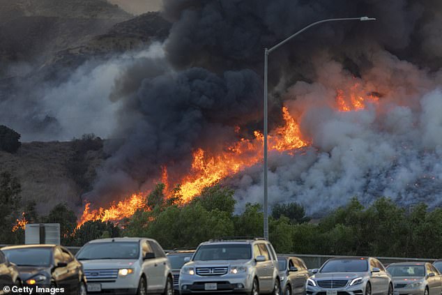 The Climactic Change study comes at the tail end of a year filled with natural disasters. California and Colorado witnessed some of their largest wildfires on record. Pictured: A fire burning out of control last month beside a freeway in Chino Hills, California