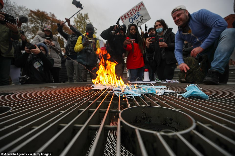 Anti-lockdown protestors burn masks in NYC following demonstrations in California