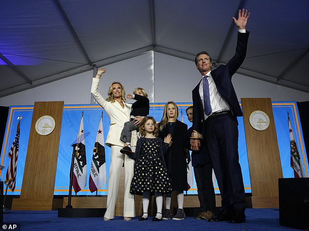 One of California Governor Gavin Newsom's four children is in quarantine after being exposed to a classmate who tested positive for the coronavirus. From left: California First Lady Jennifer Siebel Newsom, 46; Dutch, 4; Brooklynn Stacia, 7; Montana Tessa, 11; Hunter, 9; and Governor Gavin Newsom, 53, at his 2019 inauguration in Sacramento in January 2019