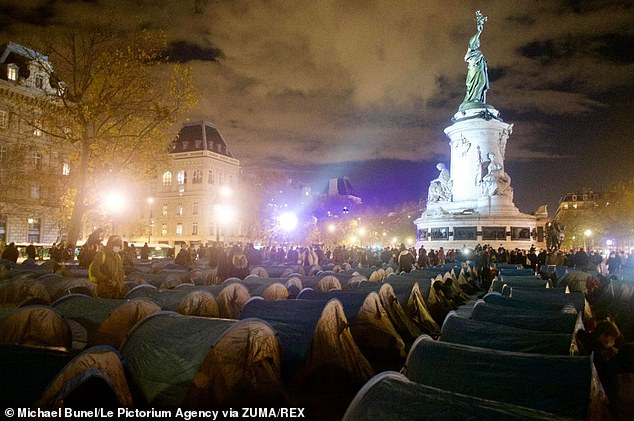 Paris police filmed violently breaking up a makeshift camp, dispersing hundreds of homeless refugees