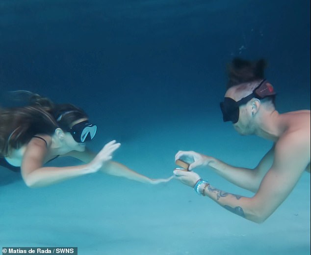 Romantic moment a man proposed to his fiancée on the seafloor of a Caribbean cave