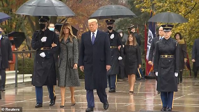 Trump is seen for first time since Sunday as he and Melania lead commemoration for Veterans Day