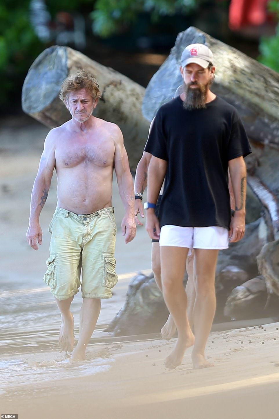 Twitter’s Jack Dorsey and a shirtless Sean Penn take a walk on the beach in Hawaii