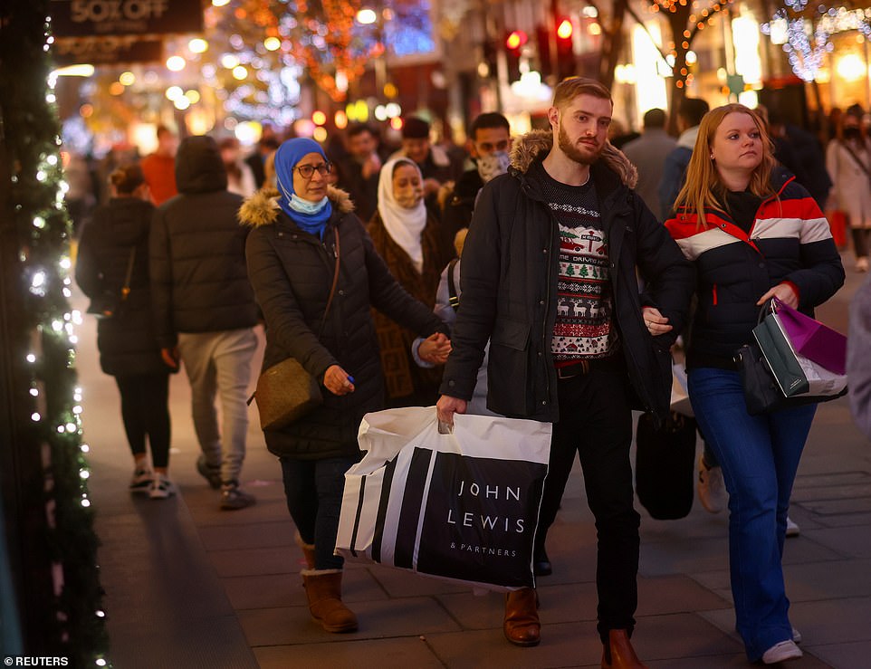 In the first non-working day since lockdown ended on December 2, shoppers were pictured carrying bags of goods and waiting in queues outside stores, including Primark and the soon-to-be-closing Debenhams