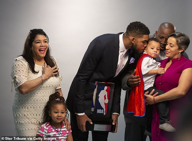 Towns is pictured with his family in 2016. He said Friday that he has been working to keep them safe from the pandemic since the death of his mother, pictured left, in April