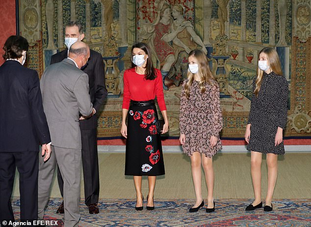 The royal completed her outfit with minimal jewellery and a pair of high stiletto heel. Pictured, Spain's King Felipe VI (L-R, back), Queen Letizia, Asturias' Princess Leonor and infanta Sofia receive members of the patronage prior to chairing the meeting