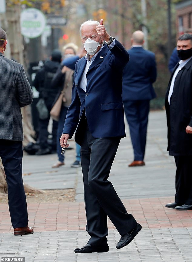 Biden gives a thumbs-up to reporters outside the Philadelphia hospital Saturday