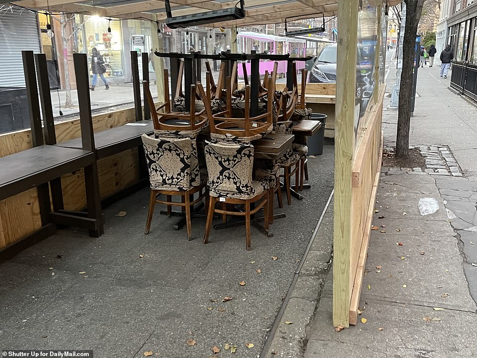 Packing up: Some restaurants started to take down or pack up their outdoor dining eating areas on Tuesday ahead of the storm