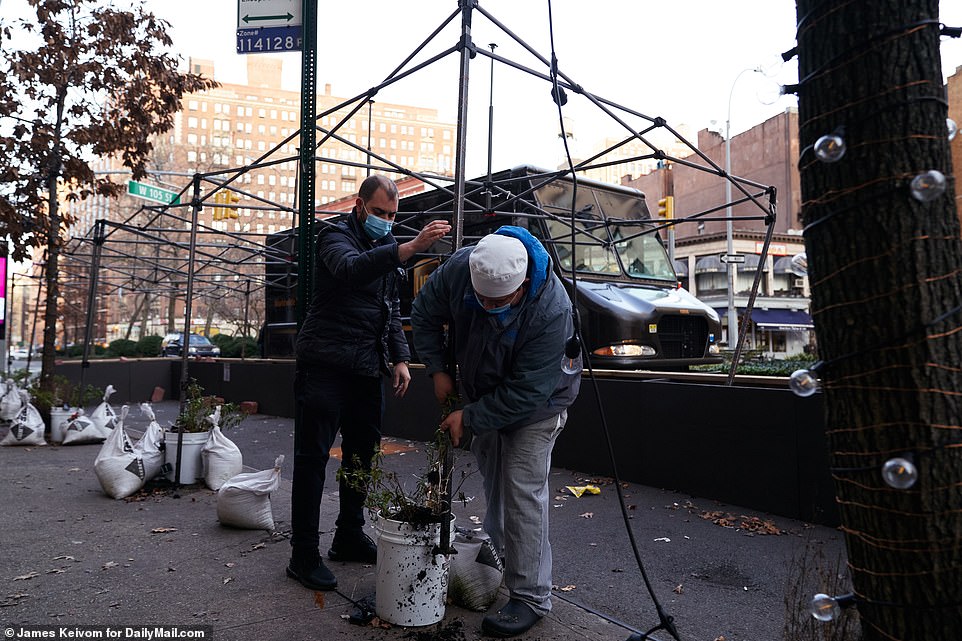 Employees at Serafina restaurant take down outdoor seating area for diners on Tuesday in Manhattan