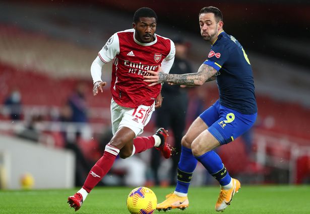 Ainsley Maitland-Niles carries the ball past Danny Ings