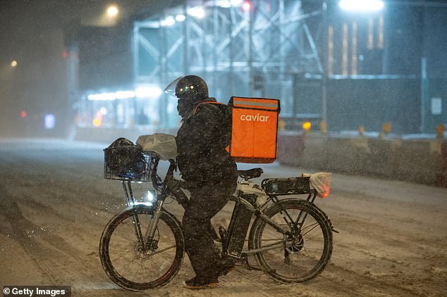 With dine-in options effectively out of the equation, deliverymen on bikes were seen pedaling in thick snow to bring New Yorkers their dinner