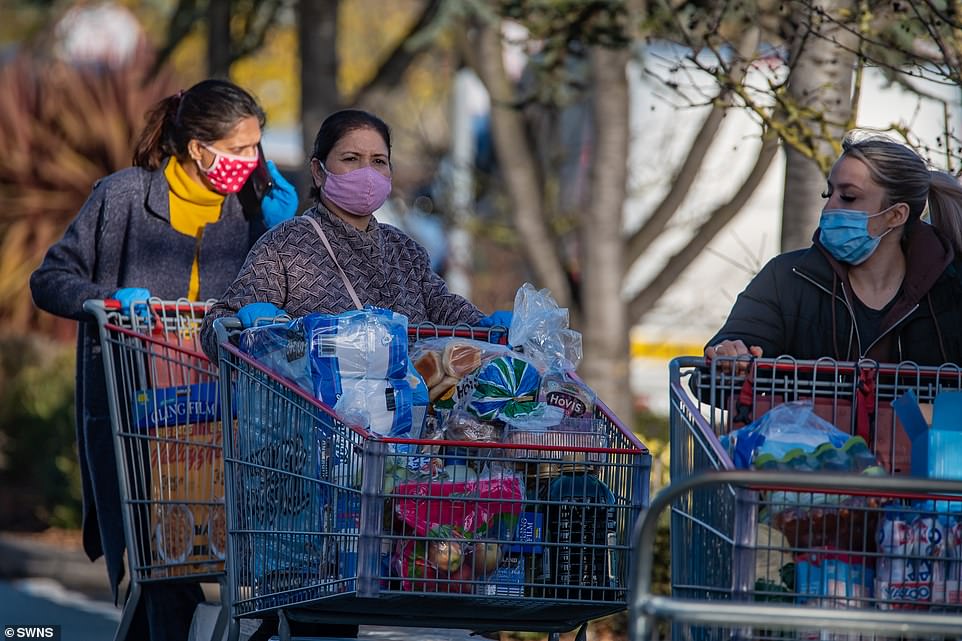 Shoppers with their trolleys filled to the brim with Christmas day essentials were seen outside Costco in Birmingham