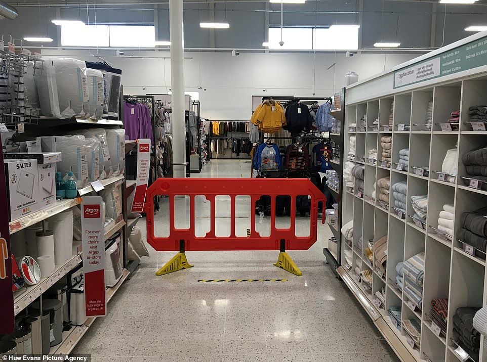 Wales was also thrust into a full lockdown from midnight last night - forcing all non-essential shops to close their doors and slashing Christmas bubbles to a single day. Pictures today emerged of a Sainsbury's supermarket in Pontypridd which blocked off non-essential sections of the store to customers (pictured)