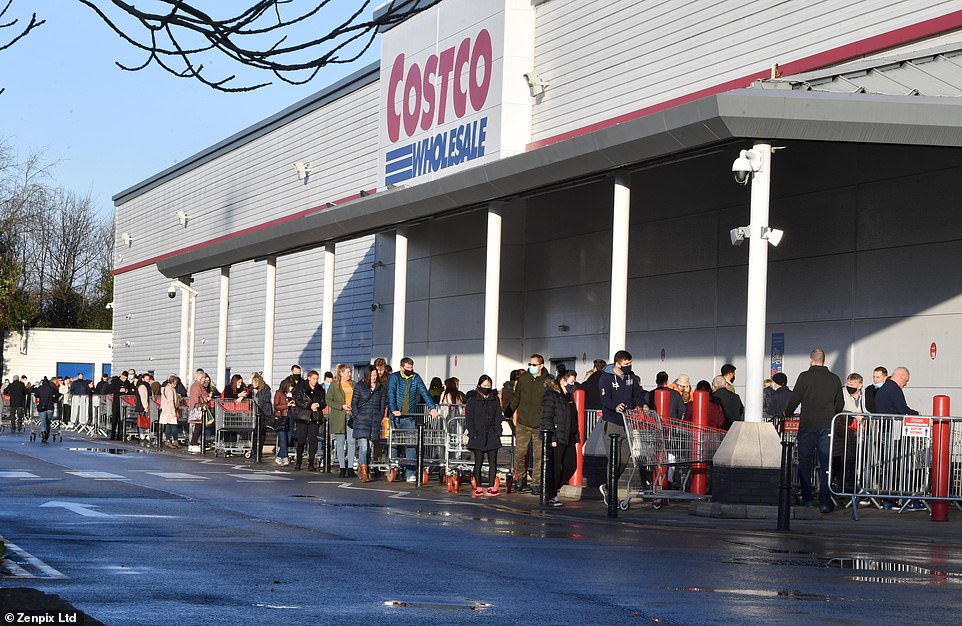 Countless Britons flocked to the country's high streets and supermarkets (queues outside Costco in Manchester, pictured) yesterday as they stocked up on Christmas essentials ahead of the big day