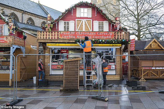 Workers removed Christmas decorations from Christmas markets on the Hayes in Cardiff today