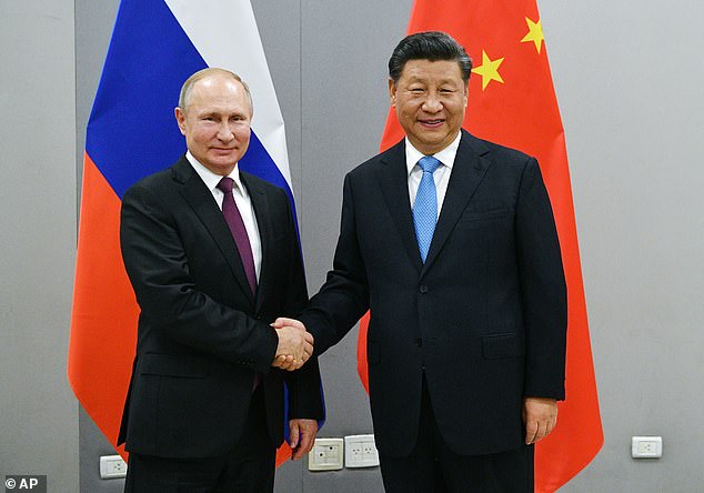 Trump asserted that China was behind the unprecedented hack on US government agencies and private sector firms, after the secretary of state said on Friday that the Kremlin was to blame. Russian President Vladimir Putin, left, and China's President Xi Jinping are pictured