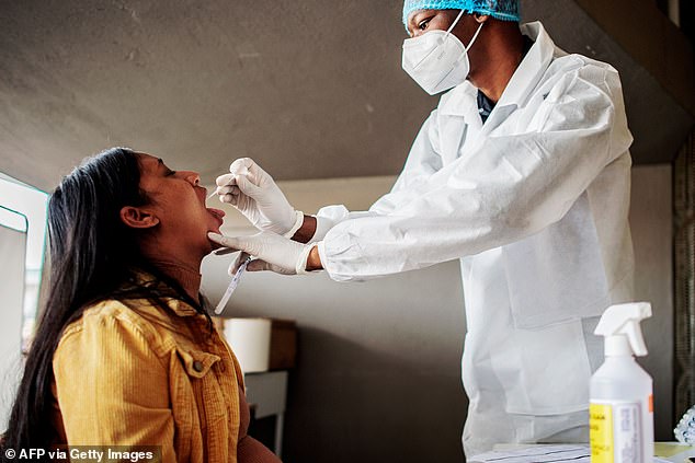 A hospital nurse performs a coronavirus test in Johannesburg last Friday on the same day the new COVID-19 variation was announced. The new variant, which is feared to be driving a surge of infections among young people, is behind a powerful second wave of the virus in South Africa