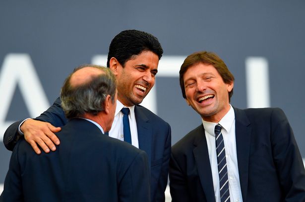 Nasser al-Khelaifi (C) shares a laugh with sporting director Leonardo