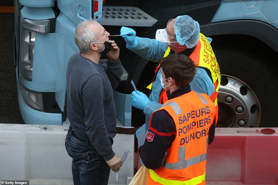 French firefighters (pictured) armed with 10,000 testing kits have joined the effort to get thousands of stranded lorry drivers across the Channel today, with up to 6,000 lorries now stacked up in Kent