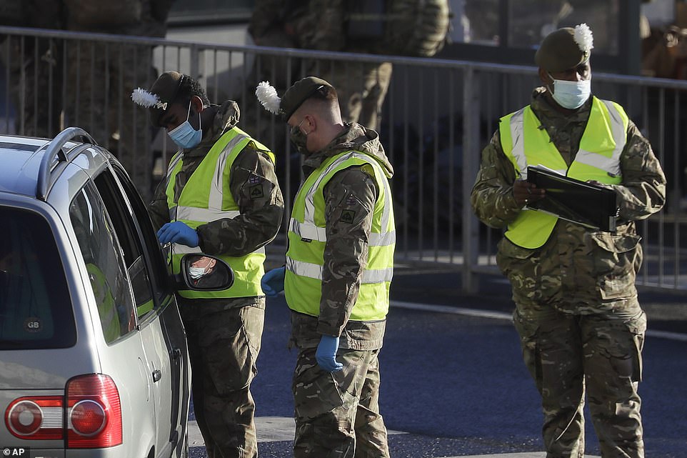 Soldiers carry out a coronavirus test on a driver at the entrance to Port of Dover in Kent amid the pandemic on Christmas Day