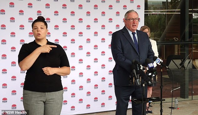 NSW Health Minister Brad Hazzard (right) slammed the 'backpackers' for not 'giving a damn about the rest of Sydney' during a press conference on Boxing Day