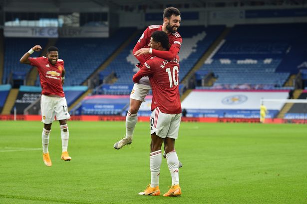 Marcus Rashford (R) celebrates with Bruno Fernandes (L) after scoring the opening goal