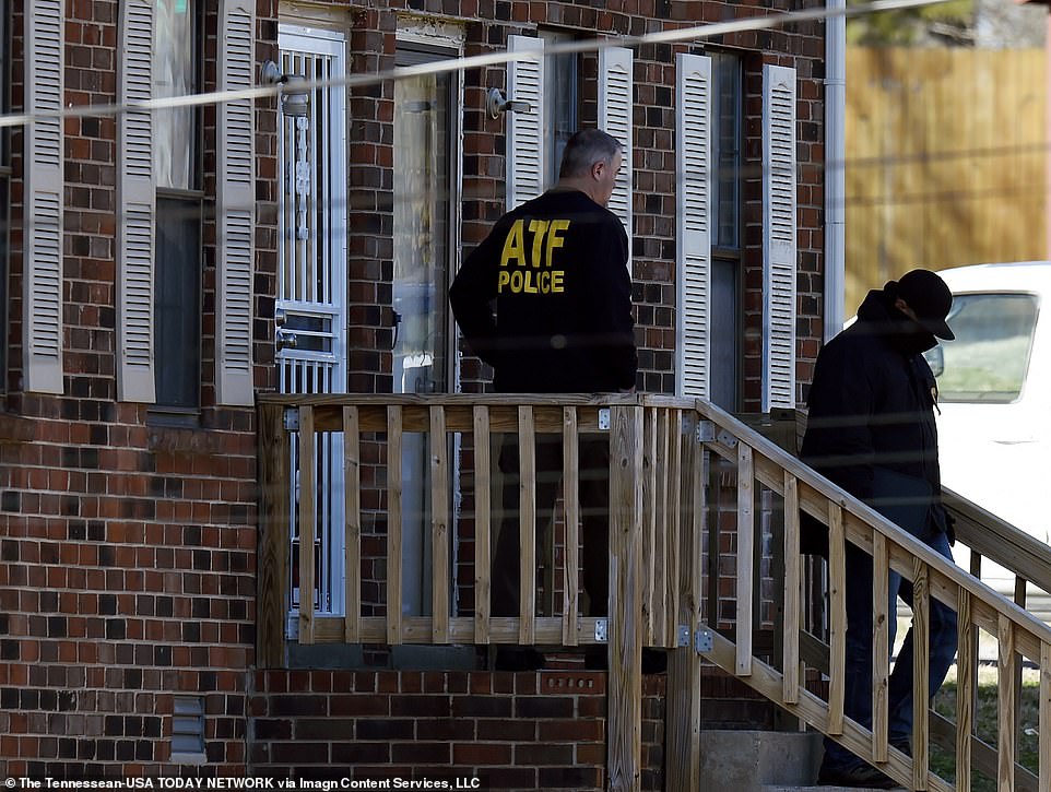 A member of the Bureau of Alcohol, Tobacco, Firearms and Explosives (ATF) is seen outside the home