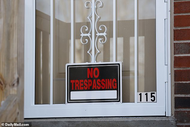 A 'no trespassing' sign also adorned the front door of Warner's duplex