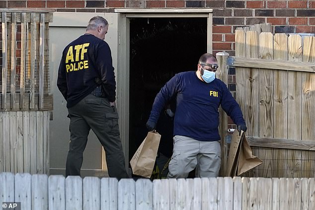 Investigators remove items from the basement of Warner's home in Antioch, Tennessee, on Saturday afternoon. A source close to the investigation said authorities are combing Warner's digital footprint in their search for a motive