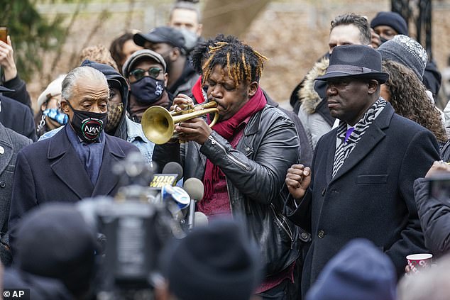 Keyon Harrold Sr. played the trumpet during the news conference, which was held as officials weigh charging the woman