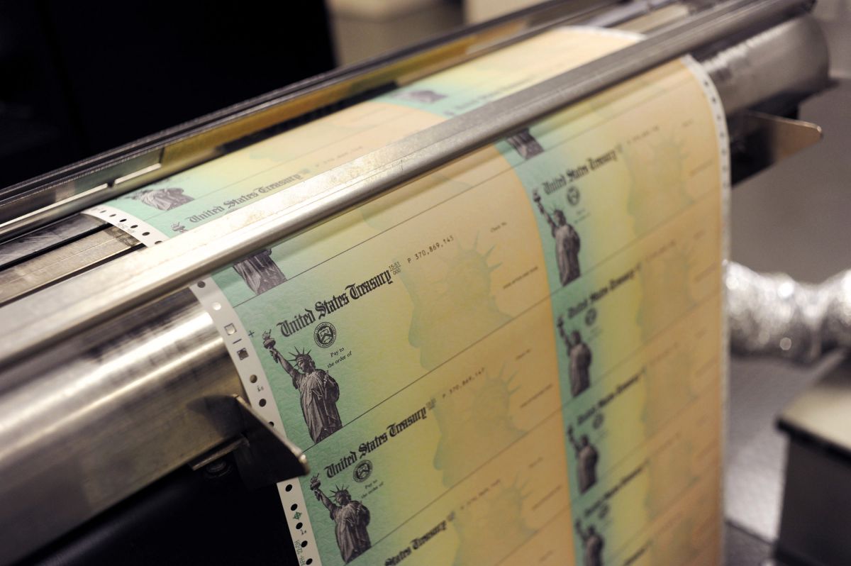 Why will some recipients of the second stimulus check receive it in the mail in February?