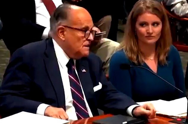Trump's legal adviser Jenna Ellis (right) gave Rudy Giuliani the side-eye on Wednesday after the 76-year-old appeared to pass gas twice during Michigan's hearing