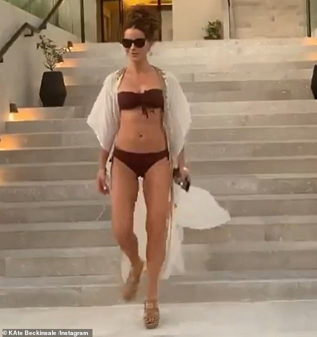 Kate Beckinsale, 47, shows off her age-defying physique in a maroon bikini