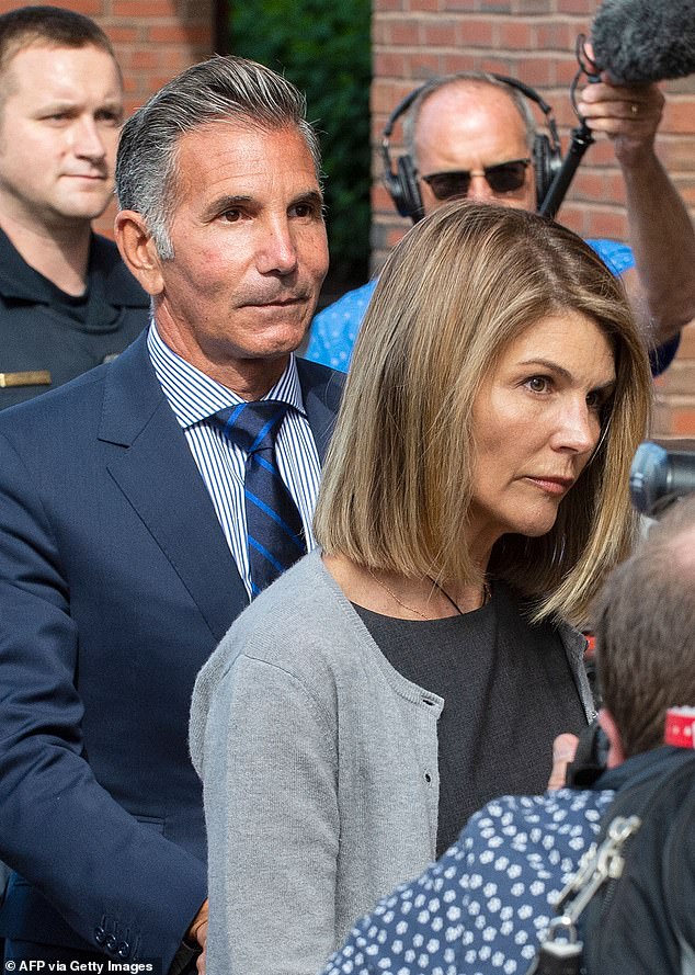 Lori Loughlin, pictured with her husband Mossimo Giannulli, left, in August last year, has been released from prison after serving two months over college admissions scandal