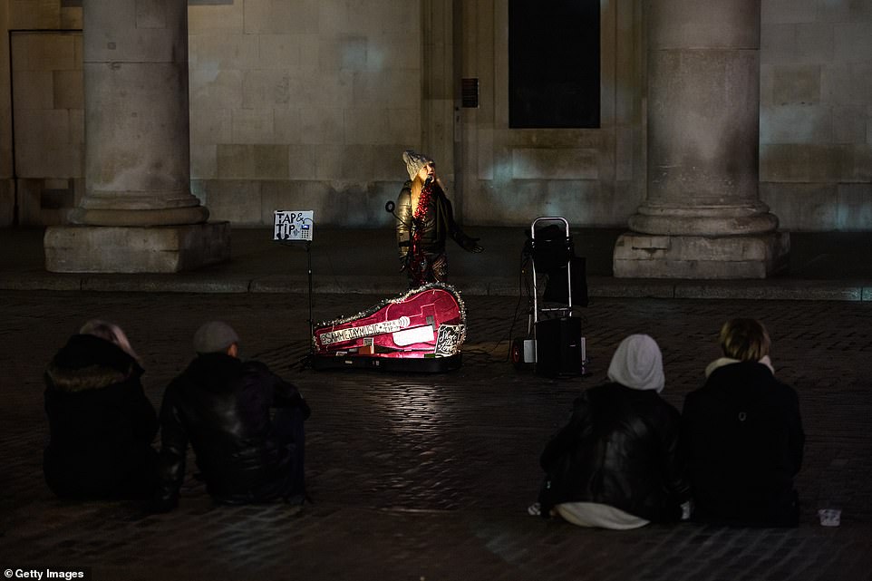 LONDON: A busker performs to a handful of people in Covent Garden on New Year's Eve this year as lockdown rule put a halt to normal gatherings