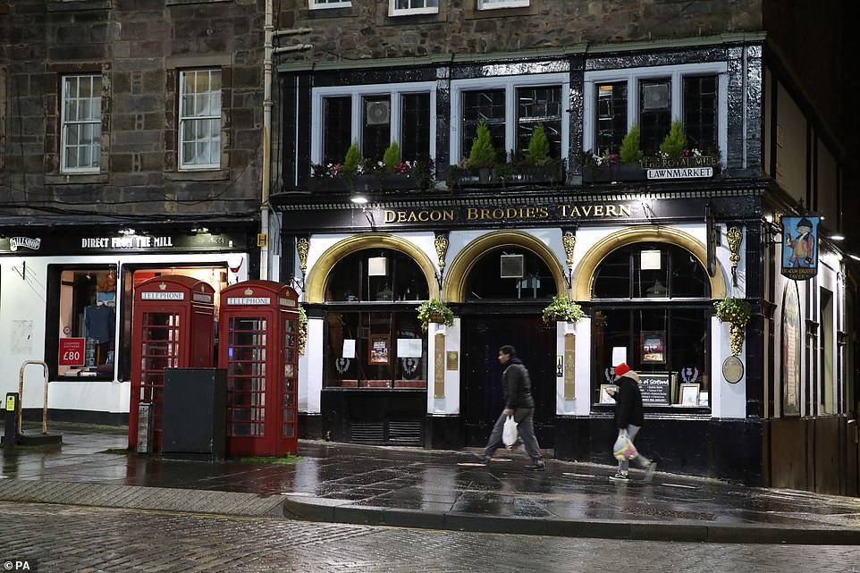 EDINBURGH: Locals walked past a shut pub in Edinburgh as Hogmanay celebrations take place online this year