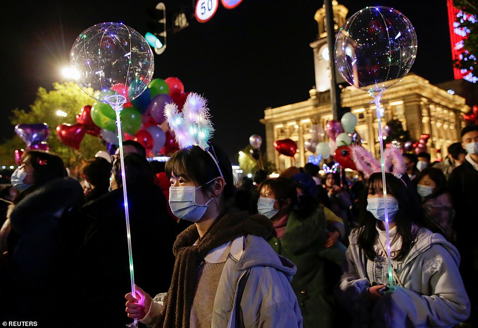 WUHAN: Women wearing masks hold up balloons as the Chinese city which shot to infamy in 2020 after giving the world the coronavirus counted down to 2021