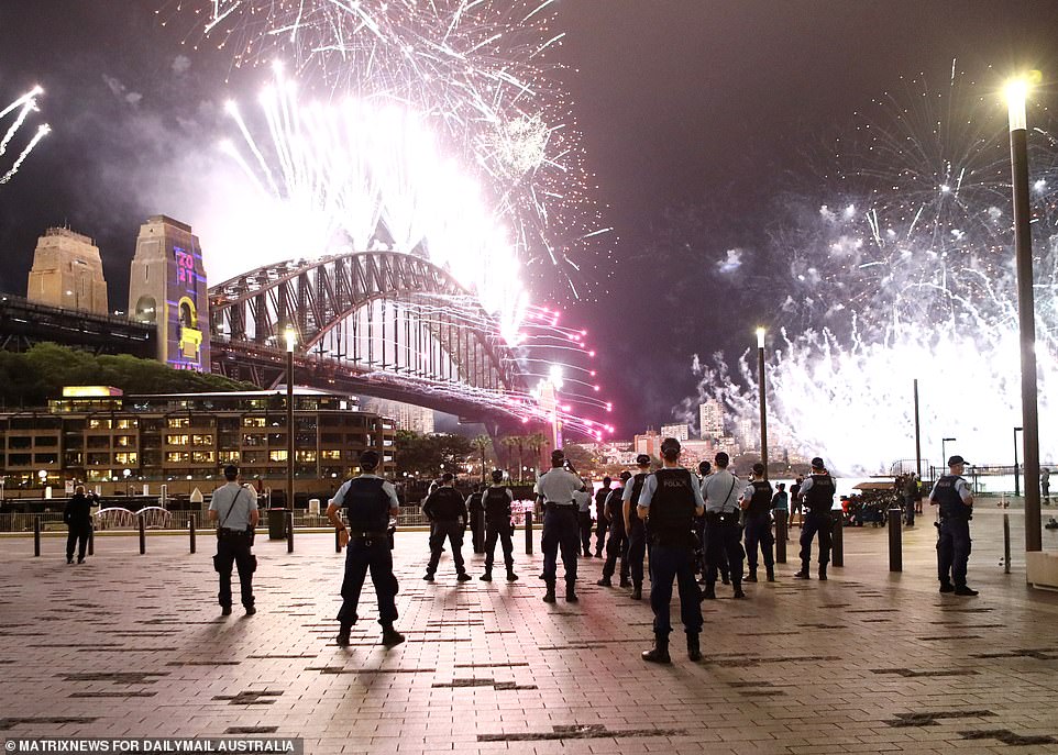 A large gathering of police patrol near a deserted Circular Quay in the Sydney CBD to watch the annual fireworks display