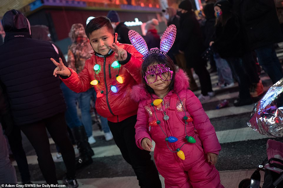 Children are seen with decorative accessories as they pose for a photo near Times Square on Thursday