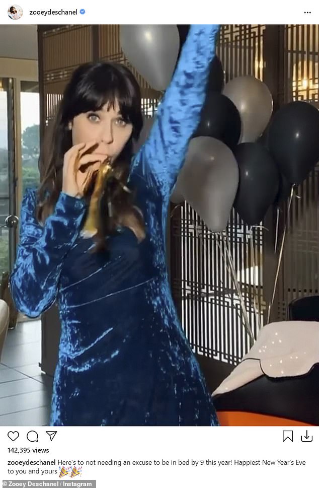 Excited: Zooey Deschanel wished her social media followers a happy new year while wearing a blue dress and blowing on a party horn